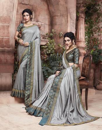 Grab This Pretty Attractive Saree In Grey Color Paired With?Contrasting Navy Blue Colored Blouse. This Saree Is Fabricated On Soft Art Silk Paired With Brocade Fabricated Blouse. Its Rich Fabric And Color Will Earn You Lots Of Compliments From Onlookers.?