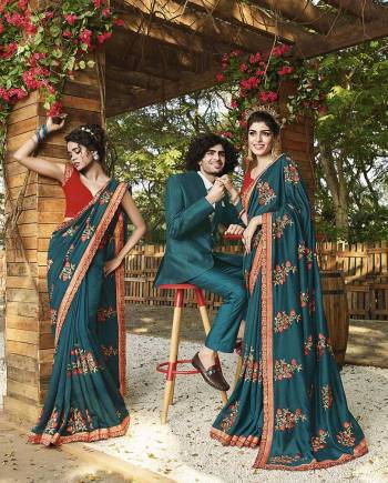 Here Is A Rich Silk Based Designer Saree In Blue Color Paired With Red Colored Blouse. This Pretty Saree Is Beautified With Detailed Embroidery Giving An Attractive Look. 