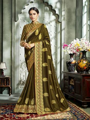 Grab This Pretty Attractive Saree In Olive Green Color. This Saree?Is Fabricated On Art Silk Paired With Brocade Fabricated Blouse. It Has Attractive Jari Embroidered Motifs With Detailed Weaved Broad Border. Its Rich Fabric And Color Will Earn You Lots Of Compliments From Onlookers.