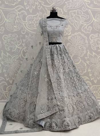 Here Is A Very Pretty Heavy Designer Lehenga Choli For The Bridesmaid In This Lovely Grey Color. This Detailed Embroidered Lehenga Choli And Dupatta Are Fabricated On Net Which Is Light Weight, Durable And Gives A Pretty Look The Personality. Buy This Pretty Piece Now