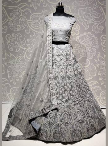 Here Is A Very Pretty Heavy Designer Lehenga Choli For The Bridesmaid In This Lovely Grey Color. This Detailed Embroidered Lehenga Choli And Dupatta Are Fabricated On Net Which Is Light Weight, Durable And Gives A Pretty Look The Personality. Buy This Pretty Piece Now