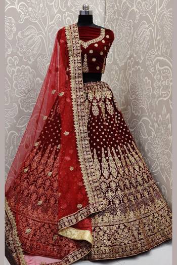 Get Ready For Your D-Day With This Heavy Designer Lehenga Choli In Maroon Color. This Heavy Embroidered Lehenga Choli Is Fabricated On Velvet Paired With Net Fabricated Dupatta. It Is Beautified With Heavy Jari Embroidery And Stone Work. Buy This Bridal Lehenga Now.