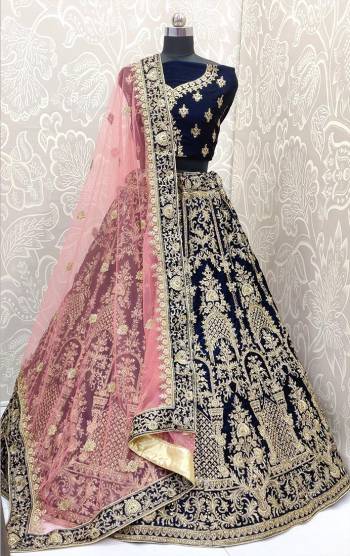 Look Pretty In This Trending Color For Bridal Wear In Navy Blue Color Paired With Contrasting Baby Pink Colored Dupatta. This Very Beautiful Heavy Designer Lehenga Choli Is Fabricated on Velvet Paired With Net Fabricated Dupatta. Buy Now. Its Attractive Embroidery And Color Will Definitlely Earn You Lots Of Compliments From Onlookers.