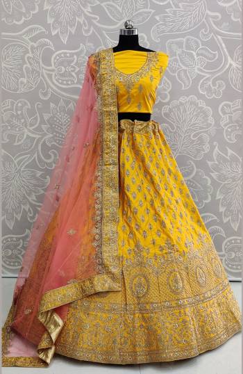 Look Pretty In This Very Beautiful And Heavy Designer Lehenga Choli In Yellow Color Paired With Contrasting Baby Pink Colored Dupatta. Its Heavy Embroidered Blouse And Lehenga Are Fabricated On Satin Silk Paired With Net Fabricated Dupatta. Buy Now