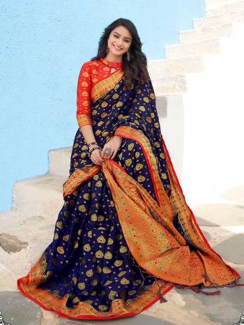 For A Proper Traditional Wear, Grab This Designer Silk Based Saree In Navy Blue Color Paired With Contrasting Orange Colored Blouse. This Saree Is Fabricated On Nylon Crepe Silk Paired With Art Silk Fabricated Blouse. It Is Beautified With Heavy Weave All Over. 