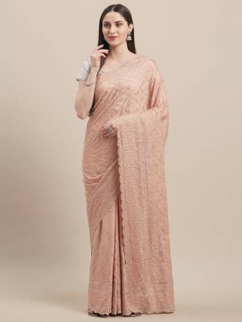 You Will Definitely Earn Lots Of Compliments Wearing This Heavy Designer Saree In Peach Color Paired With Silver Colored Blouse. This Pretty Saree IS Georgette Based Beautified With Heavy Detailed Tone To Tone Embroidery All Over Paired With Art Silk Fabricated Blouse. 