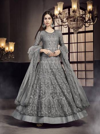 Flaunt Your Rich And Elegant Taste Wearing This Heavy designer Floor Length Suit In All Over Grey Color. Its Top And Dupatta Are Net Based Paired With Santoon  Bottom. 