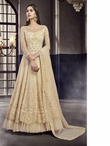 Flaunt Your Rich And Elegant Taste Wearing This Heavy designer Floor Length Suit In All Over Cream Color. Its Top And Dupatta Are Net Based Paired With Santoon  Bottom. 