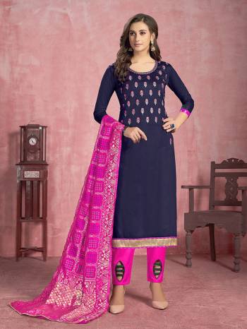 Here Is A Pretty Designer Dress Material In Navy Blue Colored Top Paired With Rani Pink Colored Bottom and Dupatta. Its Top Is Fabricated On Cotton Paired With Semi Lawn Bottom And Banarasi Silk Dupatta. 