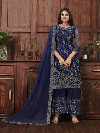 Here Is A Beautiful Heavy Embroidered Designer Suit In Navy Blue Color Which Also Comes With A Heavy Embroidered Jacket, This Pretty Suit Is Net Based With Satin Inner. Buy This Semi-Stitched Suit Now.