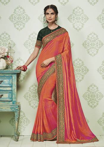 Celebrate This Festive Season With beauty And Comfort Wearing This Designer Saree In Orange And Pink Color Paired With Contrasting Dark Green Colored Blouse. This Saree And Blouse Are Silk Based Beautified With Minimal Embroidery. 