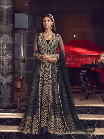 For An Elegant Look, Grab This Heavy Designer Indo-Western Suit In Navy Blue Color. Its Has Beautiful Embroidered Net Based Gown With Net Jacket, Paired With Soft silk Fabricated Bottom And Net Dupatta. Its Detailed Embroidery Will Give An Attractive Look To Your Personality. 