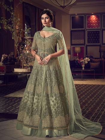 Here Is A Beautiful Pastel Green Colored Two Way Designer Suit With Comes With Two Bottom. Its Top Is Fabricated On Net Beautified With Heavy Embroidery Paired With Net Fabricated Lehenga And Art Silk Fabricated Embroidered Pants. Also It Has Net Fabricated Dupatta. 