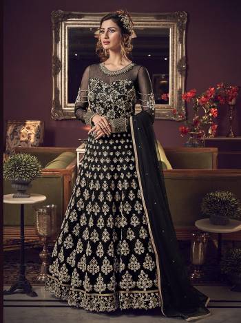 For A Bold And Beautiful Look Grab This Heavy Designer Floor Length Suit In Black Color. Its Heavy Embroidered Top Is Fabricated On Net Paired With Soft Silk Bottom And Net Dupatta. 