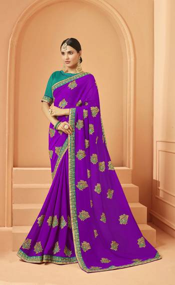 Add This Very Pretty And Elegant Looking Designer Saree In Purple Color Paired With Contrasting Sea Green Colored Blouse. This Saree Is Fabricated On Georgette Beautified With Pretty Embroidered Motifs Paired With Art Silk Fabricated Blouse. 