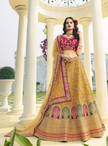 Here Is A Very Beautiful Heavy Designer Lehenga Choli For The Upcoming Wedding Season In Dark Pink Colored Blouse Paired With Contrasting Musturd Yellow Colored Lehenga And Dupatta. It Is Beautified With Heavy Detailed Embroidery Giving An Attractive Look. 