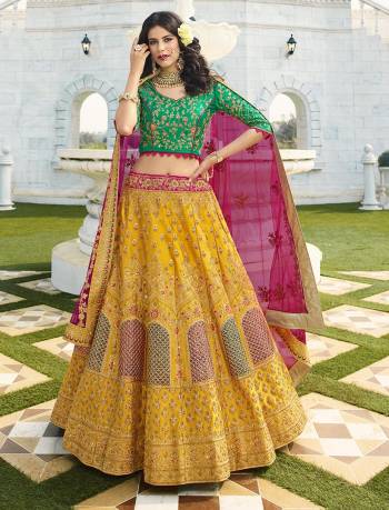 Go Colorful With This Attractive Looking Heavy Designer Lehenga Choli In Green Colored Blouse Paired With Contrasting Musturd Yellow Colored Lehenga And Dark Pink Colored Dupatta. Buy Now.