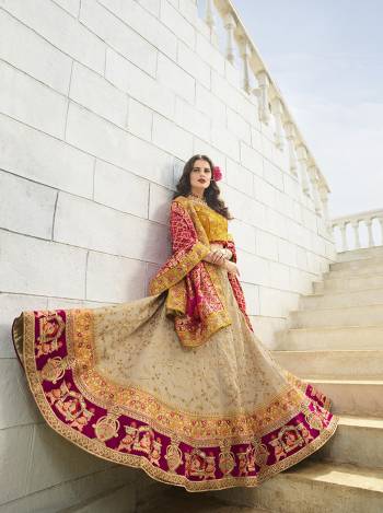 You Will Definitely Earn Lots Of Compliments Wearing This Heavy Designer Lehenga Choli In Musturd Yellow Colored Blouse Paired With Cream Lehenga And Red And Pink Colored Dupatta. Its Blouse and Lehenga Are Fabricated On Satin Silk Paired With Banarasi Jacquard Dupatta. 