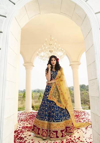 Catch All The Limelight At The Next Wedding You Attend Wearing This Heavy Designer Lehenga Choli In Royal Blue Color Paired With Contrasting Yellow Colore Dupatta. This Lehenga Choli Is Fabricated On Art Silk Paired With Net Fabricated Dupatta. Buy Now.