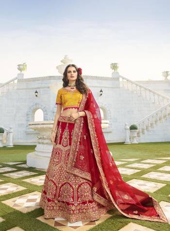 Here Is A Very Beautiful Heavy Designer Lehenga Choli For The Upcoming Wedding Season In Musturd Yellow Colored Blouse Paired With Contrasting Red Colored Lehenga And Dupatta. It Is Beautified With Heavy Detailed Embroidery Giving An Attractive Look. 