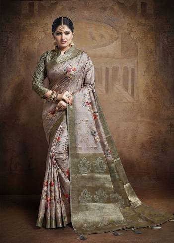 Flaunt Your Rich And Elegant Taste Wearing This Designer Saree In Mauve Color Paired With Dark Grey Colored Blouse. This Saree And Blouse Are Fabricated On Jacquard Silk Beautified With Weave All Over. 