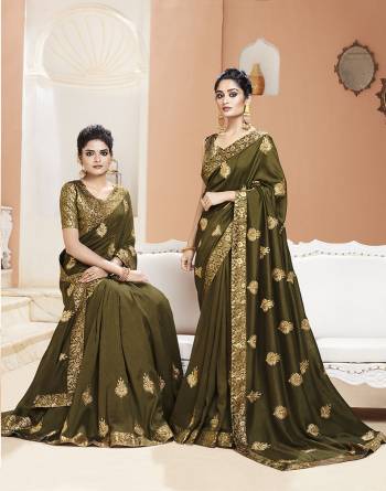 Celebrate This Festive Season Wearing This Designer Saree In Olive Green Color. This Saree Is Fabricated On Art Silk Paired With Brocade Fabricated Blouse. It Is Beautified with Jari Embroidery And Weaving. 