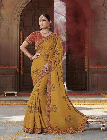 Celebrate This Festive Season Wearing This Designer Saree In Musturd Yellow Color Paired With Orange Colored Blouse. This Saree Is Fabricated On Tussar Art Silk Paired With Art Silk Fabricated Blouse. 