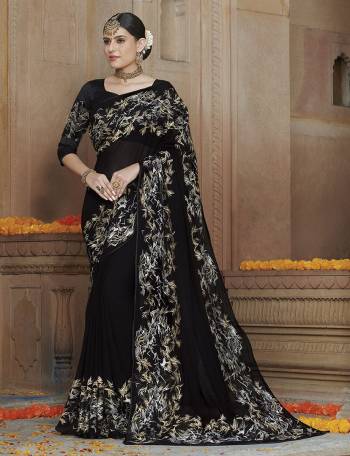 For A Bold And Beautiful Look , Grab This Very Pretty Designer Saree In Black Color Paired With Black Colored Blouse. This Saree IS Georgette Based Paired With Art Silk And Net Fabricated Blouse. Buy This Elegant Looking Saree Now.