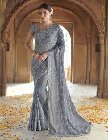 Adorn The Pretty Angelic Look In This Beautiful Grey Colored Designer Saree. This Saree Is Fabricated On Chiffon Paired With Art Silk Blouse. It Is Beautified With Tone To Tone Embroidery Giving An Elegant Subtle Look. 