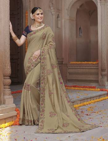 Celebrate This Festive Season Wearing This Designer Saree In Dark Cream Color Paired With Navy Blue Colored Blouse. This Saree Is Fabricated On Tussar Art Silk Paired With Crepe Silk Fabricated Blouse. 