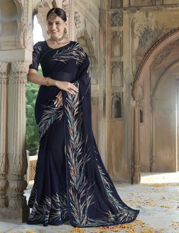 For A Bold And Beautiful Look , Grab This Very Pretty Designer Saree In Navy Blue Color Paired With Black Colored Blouse. This Saree IS Georgette Based Paired With Art Silk And Net Fabricated Blouse. Buy This Elegant Looking Saree Now.