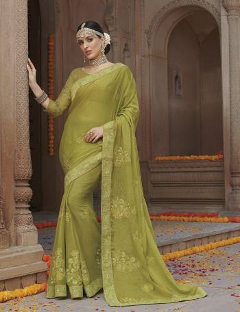 Adorn The Pretty Angelic Look In This Beautiful Parrot Green Colored Designer Saree. This Saree Is Fabricated On Chiffon Paired With Net Blouse. It Is Beautified With Tone To Tone Embroidery Giving An Elegant Subtle Look. 