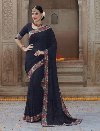 For A Bold And Beautiful Look , Grab This Very Pretty Designer Saree In Navy Blue Color Paired With Black Colored Blouse. This Saree IS Georgette Based Paired With Art Silk Fabricated Blouse. Buy This Elegant Looking Saree Now.