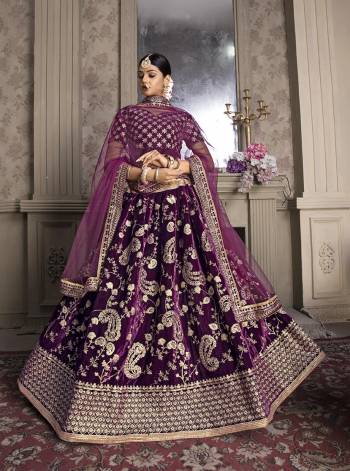 Here Is A Very Pretty Heavy Designer Lehenga Choli In All Over Purple Color. Its Heavy Embroidered Blouse And lehenga Are Velvet Based Paired With Net Fabricated Dupatta. 