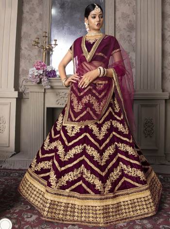 Here Is A Very Pretty Heavy Designer Lehenga Choli In All Over Wine Color. Its Heavy Embroidered Blouse And lehenga Are Velvet Based Paired With Net Fabricated Dupatta. 