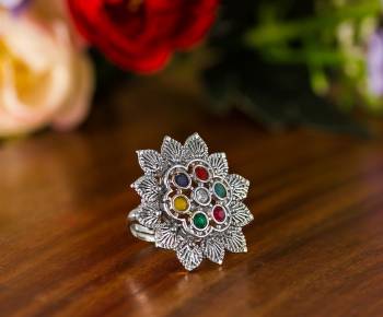 Here Is A Pretty Traditional Looking Ring In Silver Color In Oxidize Material. This Pretty Ring Is Beautified With Multi Color Stone Work And You Can Pair This Up With Any Colored Traditional Attire. Buy Now.