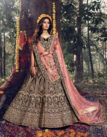 Here Is A Very Beautiful Heavy Designer Lehenga Choli For Bridal Wear In Dark Maroon Color Paired With Baby Pink Colored Dupatta. Its Blouse, Lehenga And Dupatta Are Beautified with Attractive Jari Embroidery And Stone Work. 