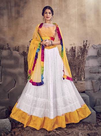 Celebrate This Festive And Wedding Season Wearing This Designer Lehenga Choli In Yellow and White Color. Its Lehenga and Dupatta Are Net Based Paired With Silk Based Blouse. Buy Now. 