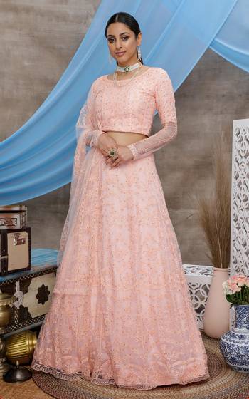 You Will Definitely Earn Lots Of Compliments Wearing This Heavy Designer Lehenga Choli In All Over Peach Color. Its Pretty Blouse, Lehenga and Dupatta Are Fabricated On Net Beautified with Tone To Tone Thread Embroidery And Stone Work. Buy This Elegant Peice Now.