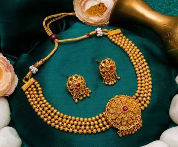 Give An Enhanced Look To Your Personality By Pairing Up This Beautiful Necklace Set With Your Ethnic Attire. This Pretty Set Is In Golden Color Beautified With Stone Work. Buy Now.