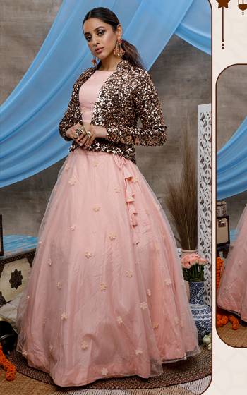 Catch All The Limelight At The Next Wedding You Attend Wearing This Designer Lehenga Choli In Pretty Peach Color Paired With Copper Colored Heavy Sequence Work Jacket. Its Pretty Blouse And Lehenga Are Net Based Paired With Velvet Fabricated Jacket. 