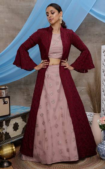 You Will Definitely Earn Lots Of Compliments Wearing This Designer IndoWestern Lehenga Choli In Dusty Pink Color Paired With Contrasting Maroon Colored Jacket. Its Elegant Embroidered Blouse and Lehenga Are Fabricated On Net Paired With Chinon Fabricated Jacket. 