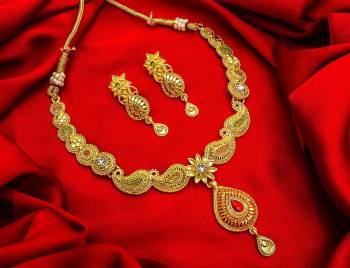 Give An Enhanced Look To Your Personality By Pairing Up This Beautiful Necklace Set With Your Ethnic Attire. This Pretty Set Is In Golden Color Beautified With Stone Work. Buy Now.