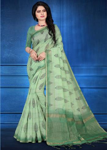 You Will Definitely Earn Lots Of Compliments Wearing This Designer Saree In Light Green Color. This Saree And Blouse Are Cotton Silk Based Beautified With Jari Checks And Prints. It Is Light In Weight And Easy To Carry All Day Long. 