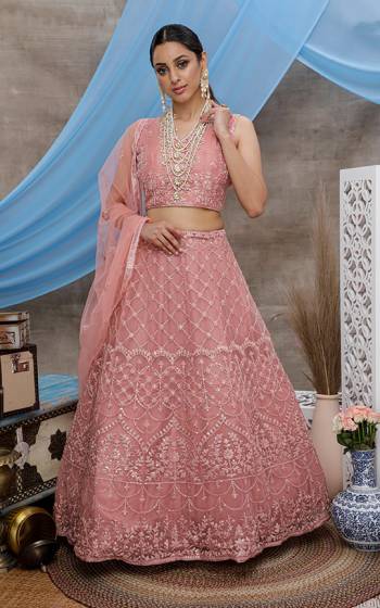 Look Pretty In This Beautiful Heavy Designer Lehenga Choli Is Dusty Pink Color. This Attractive Embroidered Lehenga Choli Is Fabricated On Net Paired With Net Fabricated Dupatta. It Is Light In Weight And Easy To Carry All Day Long. 