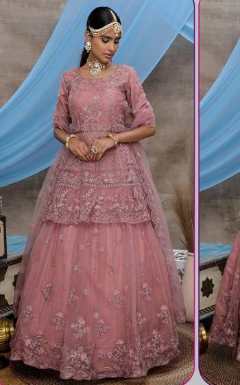 Look Pretty In This Beautiful Heavy Designer Lehenga Choli Is Dusty Pink Color. This Attractive Embroidered Lehenga Choli Is Fabricated On Net Paired With Net Fabricated Dupatta. It Is Light In Weight And Easy To Carry All Day Long. 