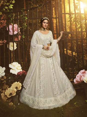 Look Like A Goddess Diva Wearing This Pretty Elegant Designer Lehenga Choli In Off-White Color. Its Blouse, Lehenga And Dupatta Are Georgette Based Beautified With Heavy Yet Subtle Looking Embroidery All Over. 