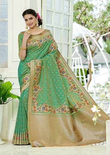 Add This Beautiful And Elegant Looking Saree To Your Wardrobe In Green Color. This Pretty Floral Weaved Saree Is Fabricated On Banarasi Silk Paired With Art Silk Fabricated Blouse. 