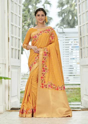 Add This Beautiful And Elegant Looking Saree To Your Wardrobe In Musturd Yellow Color. This Pretty Floral Weaved Saree Is Fabricated On Banarasi Silk Paired With Art Silk Fabricated Blouse. 