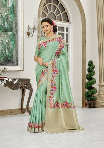 Add This Beautiful And Elegant Looking Saree To Your Wardrobe In Sea Green Color. This Pretty Floral Weaved Saree Is Fabricated On Banarasi Silk Paired With Art Silk Fabricated Blouse. 